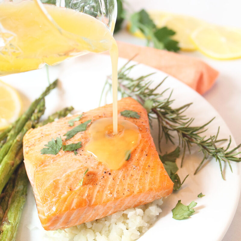 Easy Air Fryer Salmon with Lemon Butter Sauce Drizzled on it