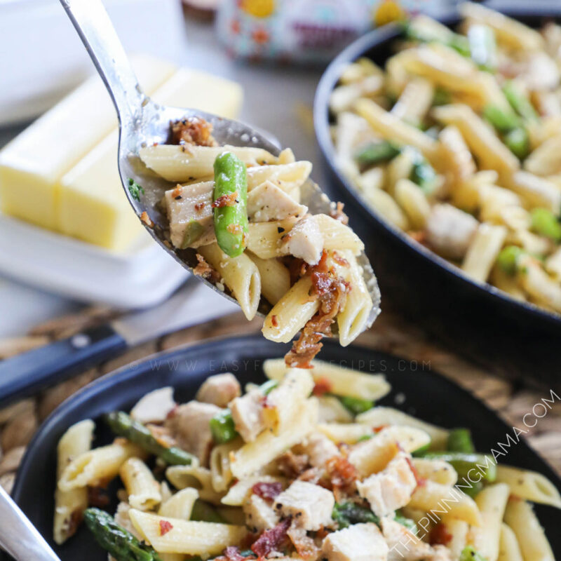 Garlic Butter Pasta with Chicken, Bacon and Asparagus Being Served